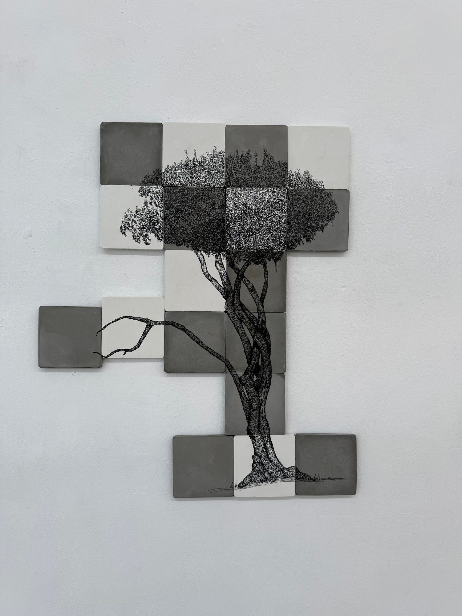 Square tiles forming a tree drawing on the gallery wall