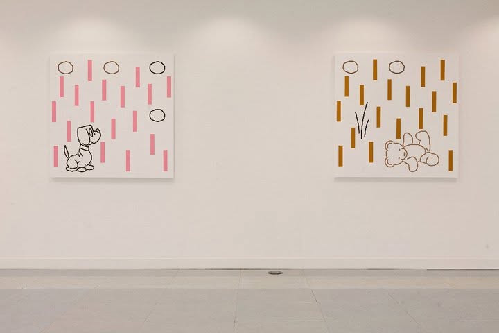 Two square paintings hung side by side, showing line drawings of a puppy and a teddy bear among dashes and rings